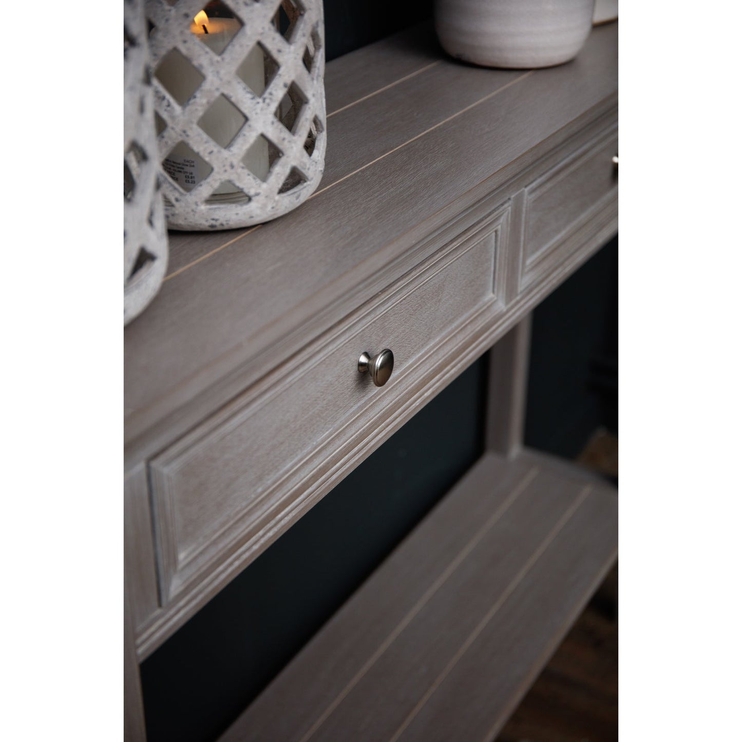 two drawer console table with candle lantern and vase to the top