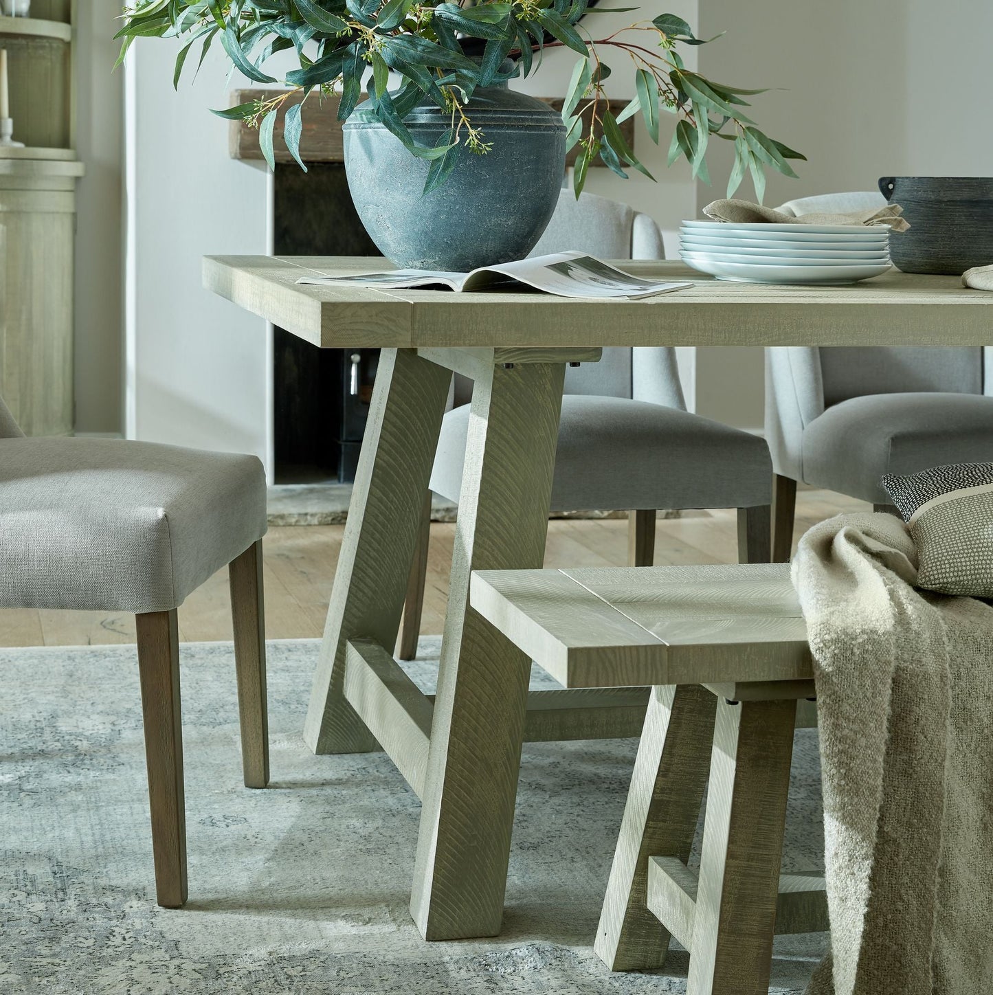 leg detail of dining table, matching bench can just be seen