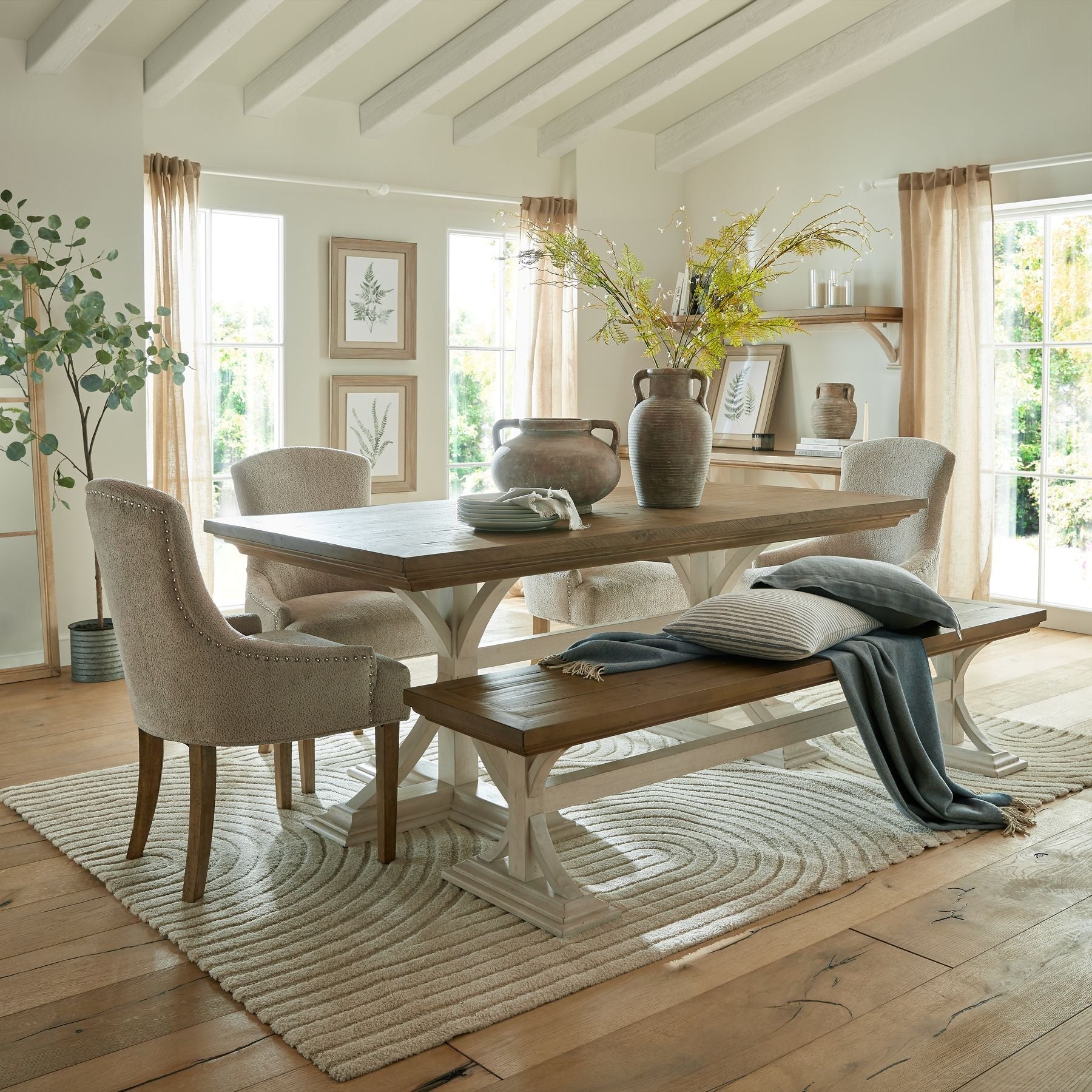 large amphora vase, next to small amphora style pot on large dining table