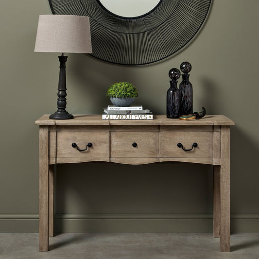 console table, with lamp on top, two bottle vases and decor books with small artificial plant to the top