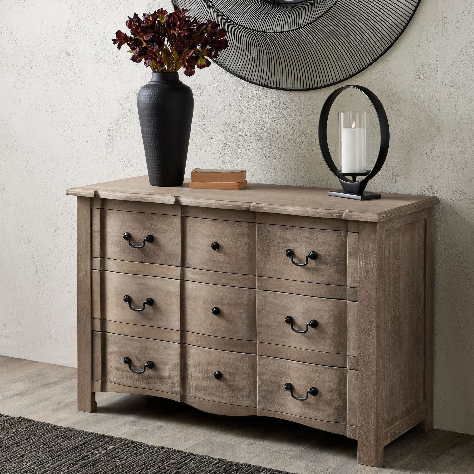 3 drawer chest with hammered black ginger jar to the top, round black candle holder and two decorative books