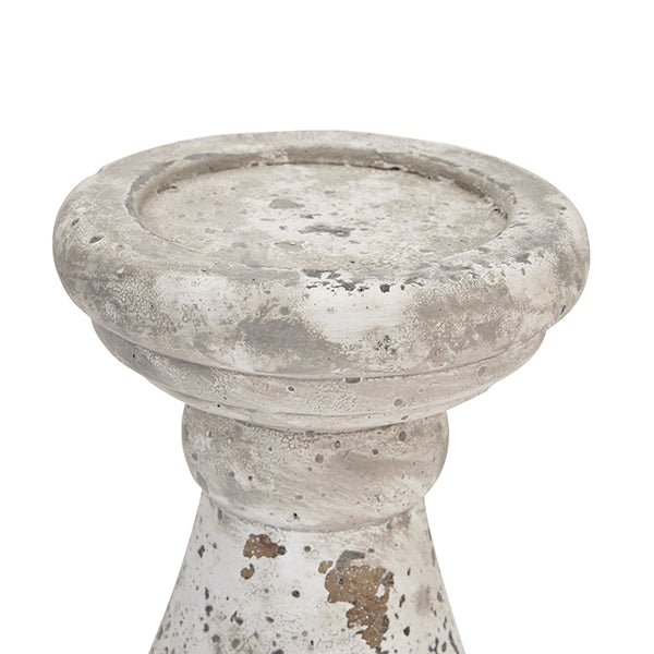 Top detail of aged stone candle stick, showing the lipped edge that keeps the candle in place