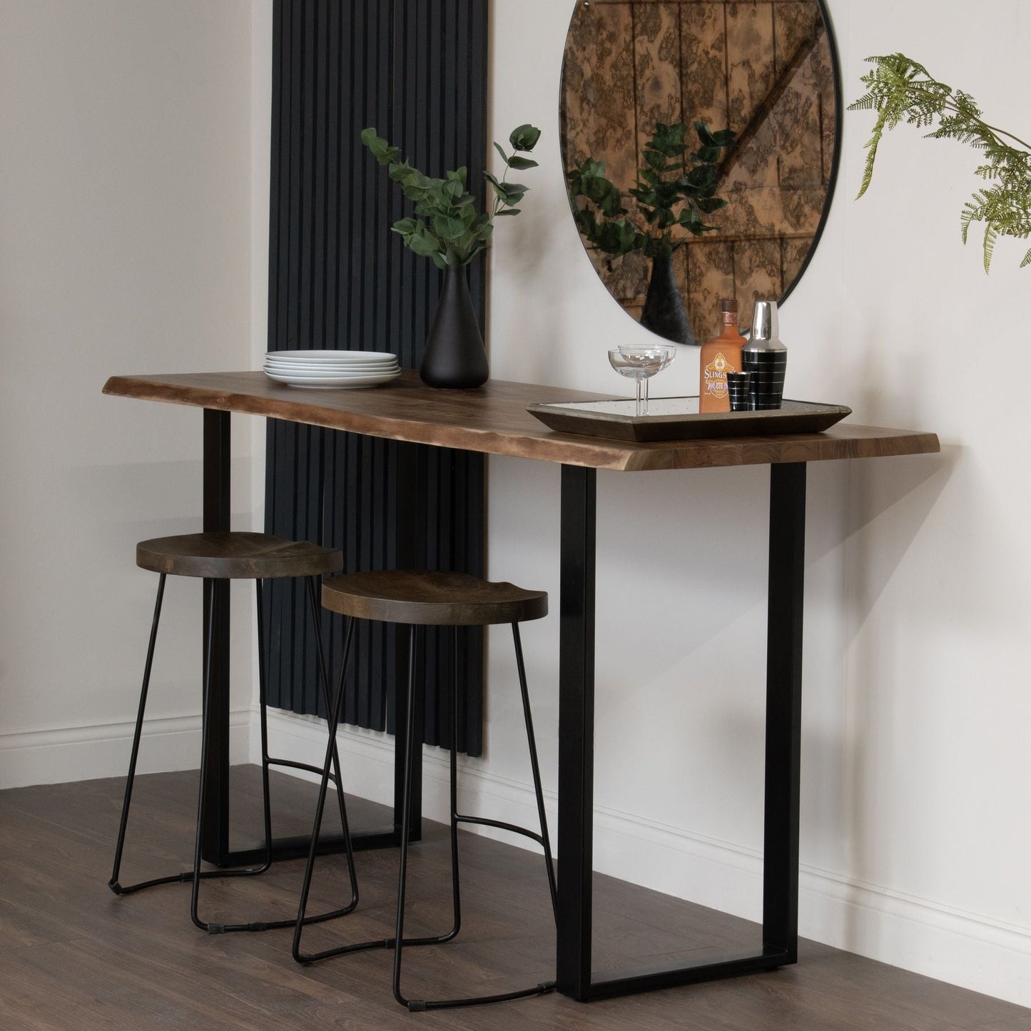 bar table set up with two glamis hardwood bar stools and an aged mirror to the wall behind