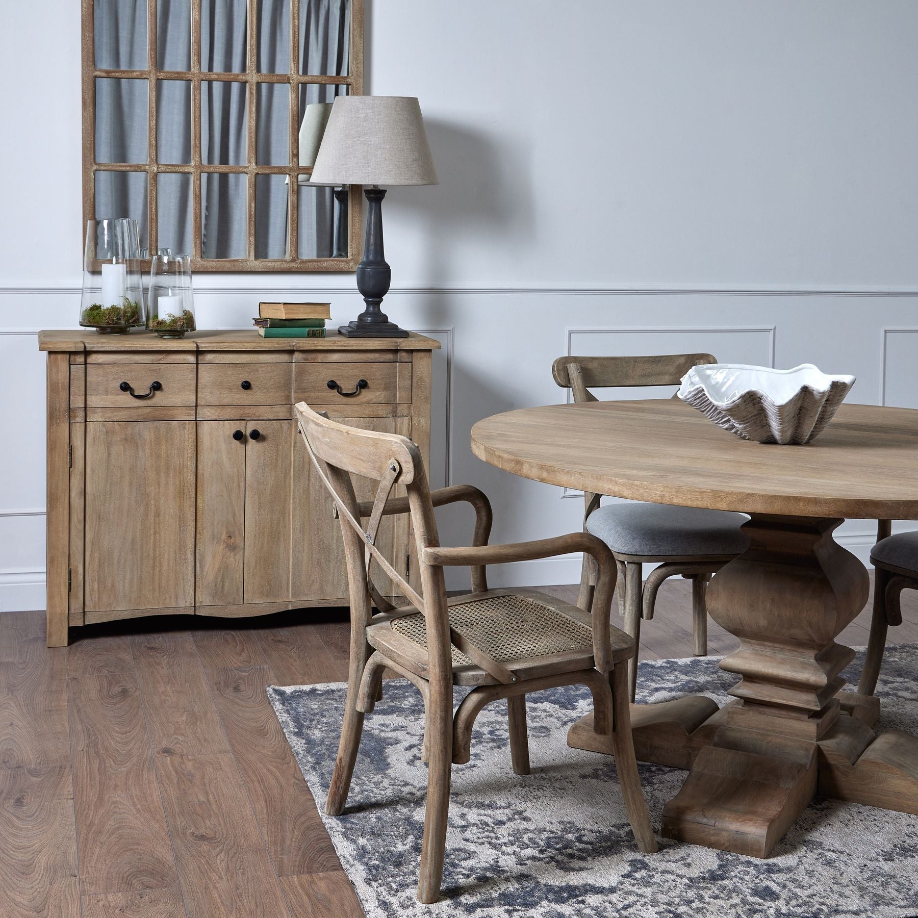 room set, sideboard in the background with round dining table in the foreground with clam shell bowl in the centre