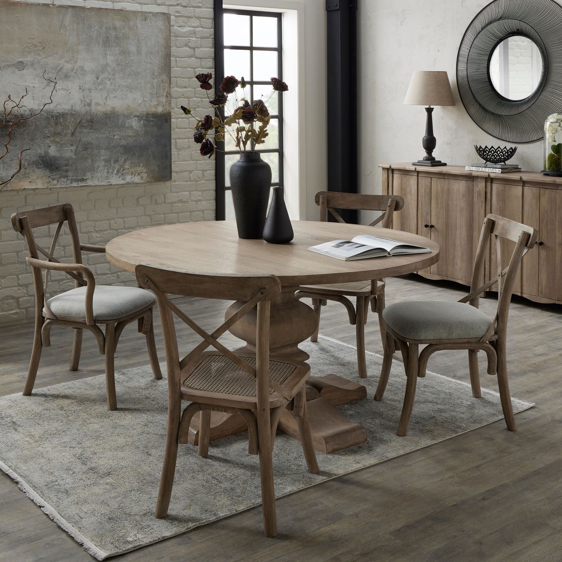 room set showing 4 chairs around round dining table with 4 door sideboard in the background