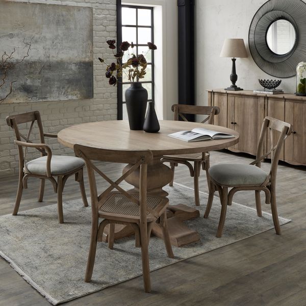 round dining table set up with matching dining chairs, large sideboard can be seen behind