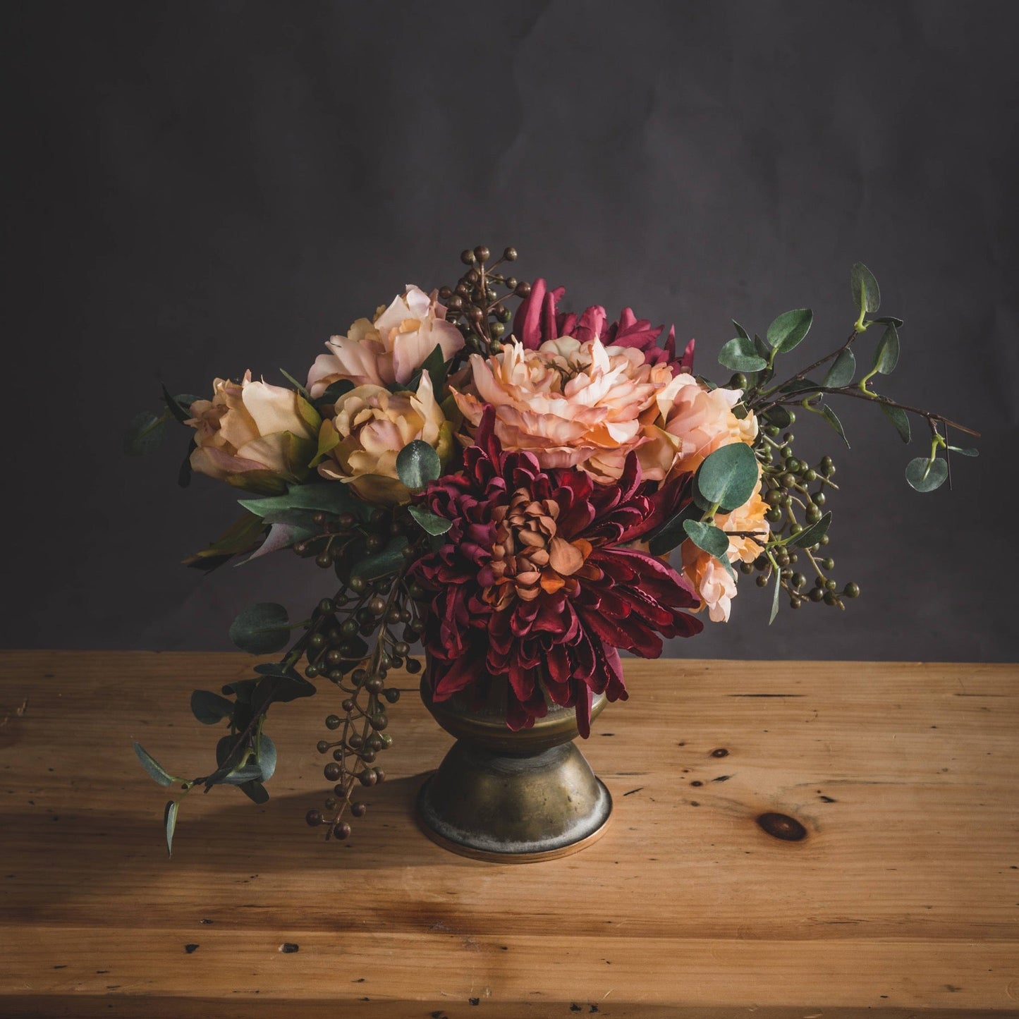 spider chrysanthemum in floral display with hydrangeas and berries in bronze vase