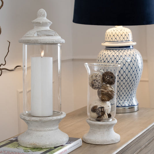 Stone lantern with LED Flameless candle in, next to smaller version. Lamp is in the background